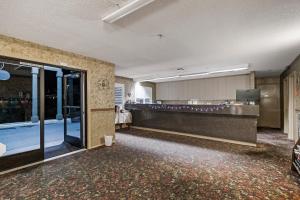 an empty lobby with a waiting room and a glass door at Country Inn Sonora in Sonora