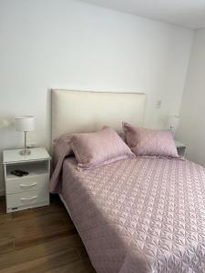 1 dormitorio con 1 cama grande y mesita de noche en Departamento en Mar del Plata centro en Mar del Plata