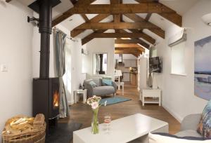 a living room with a fireplace and a couch at Lavender Cottage - Gonwin Manor in Carbis Bay