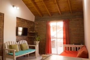a living room with two chairs and a window at Departamento Puerto Madryn! Patagonia Beach in Puerto Madryn