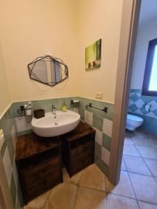 a bathroom with a sink and a mirror at Sweet House in Villasimius +38 photos