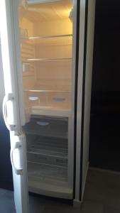 an open refrigerator with its door open with its door at Studio 2 lits jumeaux 1 station Tram aéroport Orly in Athis-Mons