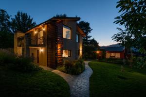 a house with a pathway in front of it at night at Sukal in El Bolsón