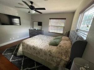 a bedroom with a bed and a ceiling fan at The perfect Gulfport Fl Getaway! in St Petersburg