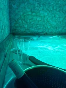 a swimming pool with two glasses in a tub at Atmosphere Hotel in Les Deux Alpes