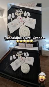 a poster of a hotel room with white towels and towels at Curti Granda in Rescaldina