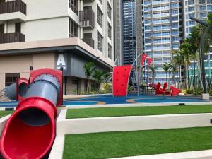 a playground in a city with a red slide at Bali Residence Melaka by Jzstay 2BR in Melaka