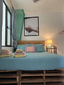 a bedroom with a bed with a blue comforter at Coqui del Mar - LGBTQ Hotel - Adults Only in San Juan