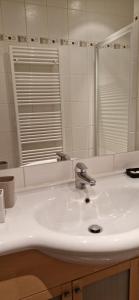 a bathroom with a white sink and a mirror at Cosy Appartement Complet centre-ville Montbéliard in Montbéliard +17 photos