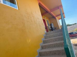 a stairway to a house with a yellow wall at Condominio puerto peñasco in Puerto Peñasco