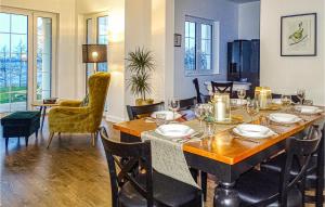 a dining room with a wooden table and chairs at Awesome Home In Srokowo With 6 Bedrooms, Wifi And Sauna in Srokowo