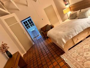 a bedroom with a bed and a chair and a window at WOODS GUEST HOUSE in Middelburg