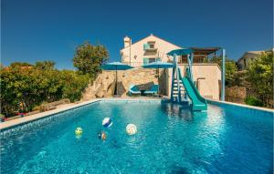 a swimming pool with a slide in a house with a pool at Awesome Home In Kornic With Kitchen in Kornić