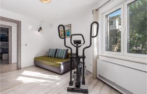 a room with a exercise bike in front of a window at Awesome Home In Kornic With Kitchen in Kornić