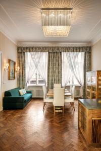 a living room with a green couch and a table at BHG Apartments Prague in Prague