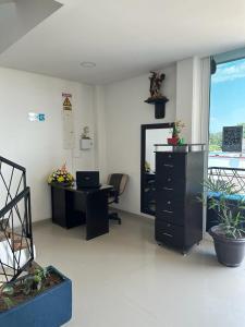 an office with a desk and a chair and a window at Hotel River Side in San Martín