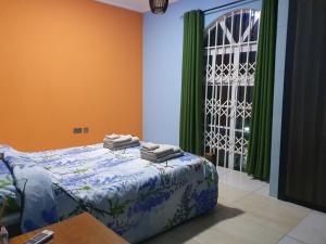 ein Schlafzimmer mit einem Bett mit Handtüchern darüber in der Unterkunft Villa Nelomoor in Kwabenyan