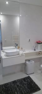 a white bathroom with a sink and a mirror at Ria Palace Apartment in Aveiro