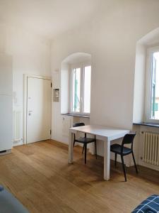 a dining room with a white table and two chairs at Casa di Matteo Ponterotto 34(zona brignole) in Genoa