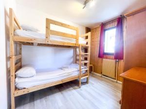 a bunk bed room with two bunk beds and a window at Atmosphere Hotel in Les Deux Alpes