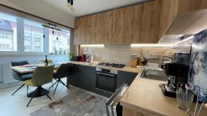 a kitchen with a stove and a table with chairs at Luxury Apart Dorobanți in Bucharest