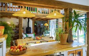 a kitchen with a table with a bowl of fruit at Nice Home In Plouguerneau With Wifi in Plouguerneau