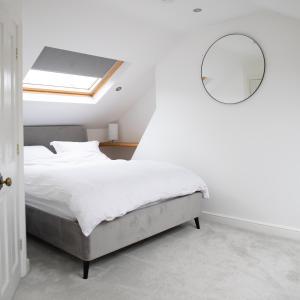 a bedroom with a bed with a skylight and a mirror at 35 Grosvenor Terrace - 3 Bed Sleeps 6, 5 min walk from York City Centre in York