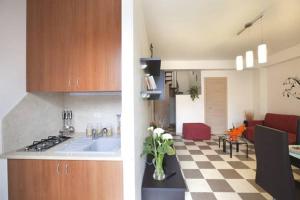 una cucina e un soggiorno con lavandino e piano cottura di Casa Vacanza Nina a Pozzallo