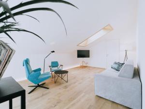 a living room with a couch and chairs and a tv at Gourmet - Boutique Hotel Tanzer in Falzes