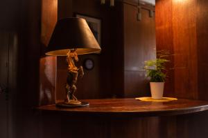 lampa na stole z posągiem w obiekcie Hotel Podkowa we Wrocławiu