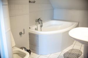 a bathroom with a sink and a bath tub at Hotel Podkowa in Wrocław