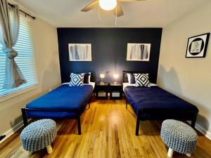 a room with two beds and two chairs in it at Plush Downtown ATL 2BD Home w/ FREE PKNG in Atlanta