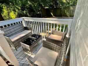 a balcony with two chairs and a bench and a grill at Plush Downtown ATL 2BD Home w/ FREE PKNG in Atlanta