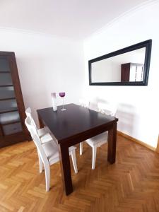 a dining room table with white chairs and a mirror at Ría de Viveiro 2 in Viveiro +20 photos