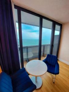 a room with a table and chairs and a large window at Orbi City in Batumi in Batumi