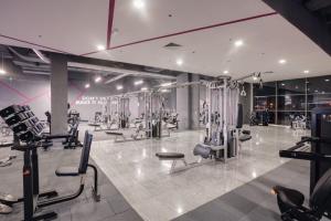 a gym with many exercise equipment in a room at Monaco Grand Apartments By CityBookings in Bucharest