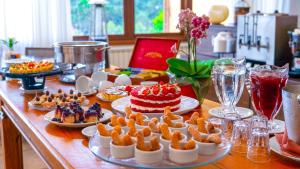 a table topped with plates of food and a cake at Hotel Le Renard - Campos do Jordao in Campos do Jordão