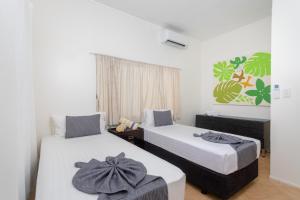 Postel nebo postele na pokoji v ubytování Moana Sands Beachfront Villas