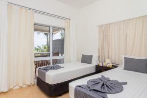 Postel nebo postele na pokoji v ubytování Moana Sands Beachfront Villas