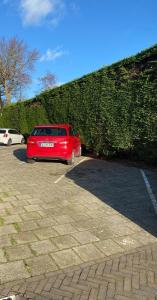 a red car parked in a parking lot at Appartement Dishoek No.46 in Koudekerke
