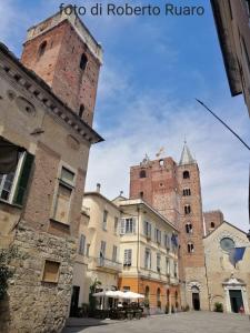 a group of buildings with towers in a city at SOLELUNA in Albenga