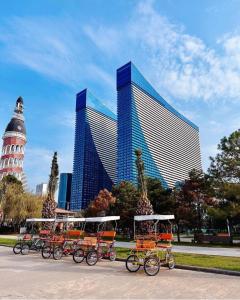 a group of rickshaws parked in front of a building at Orbi City in Batumi in Batumi