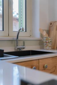 a kitchen with a sink and a counter top at Tiny house in the historic centre of Soverato in Soverato Superiore