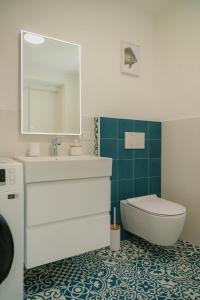 a bathroom with a sink and a toilet and a mirror at Tiny house in the historic centre of Soverato in Soverato Superiore