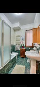 a bathroom with two sinks and a tub and a shower at Biennale Venice Charme Apartment in Venice