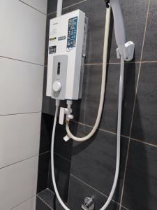 a gas meter on the wall of a bathroom at Swiss Home Horizon Suite 1 in Sepang