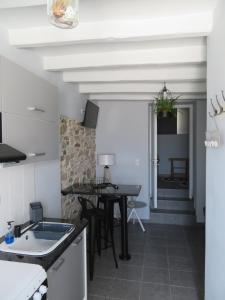 a kitchen with a table and a dining room at CASA SYRA in Ermoupoli