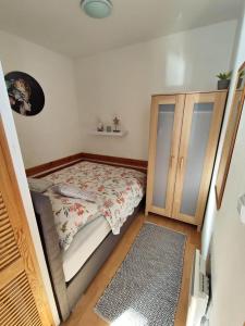 a small bedroom with a bed and a cabinet at Apartmán J+S Donovaly in Donovaly