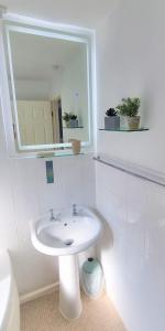a white bathroom with a sink and a mirror at Waterfront - Holes Bay, Poole, Dorset in Hamworthy
