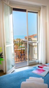 a bedroom with a large window with a view of the ocean at Hotel Selene - Vista Mare in Riccione